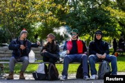 People smoke on the day Canada legalizes recreational marijuana at Trinity Bellwoods Park, in Toronto, Ontario, Canada, Oct. 17, 2018.
