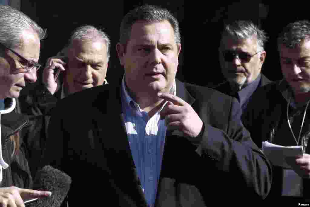 Leader of right-wing, anti-bailout Independent Greeks party Panos Kammenos (center) leaves after a meeting with head of radical leftist Syriza party Alexis Tsipras (not pictured) at the Syriza headquarters in Athens, Jan. 26, 2015.
