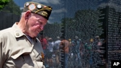 World War II Army veteran Jimmy Bishop, Jr., 87, of Old Bridge, N.J., reacts as he looks at the names on the Vietnam Veterans Memorial for the first time on Sunday, May 25, 2014.