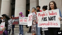In this Oct. 21, 2014 file photo, people opposed to child sex trafficking rally outside of the Washington state Supreme Court in Olympia, Wash. (AP Photo/Rachel La Corte, File)