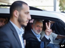 Senior Hamas leader Ismail Haniyeh gestures as leaves his office as a former Hamas government prime minister, in Gaza City June 2, 2014.