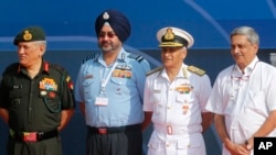 Indian Defense Minister Manohar Parrikar, right, poses with, from left, Indian Army Chief Bipin Rawat, Indian Air Force Chief Birender Singh Dhanoa and Indian Navy Chief Sunil Lanba at the opening ceremony of Aero India 2017 at Yelahanka air base in Bangalore, India, Feb. 14, 2017.
