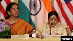 FILE - India's then-minister of commerce and industry, now minister of defense, Nirmala Sitharaman (L) and foreign minister Sushma Swaraj are seen at a U.S-India Strategic & Commercial Dialogue plenary session at the State Department, in Washington, Sept. 22, 2015.