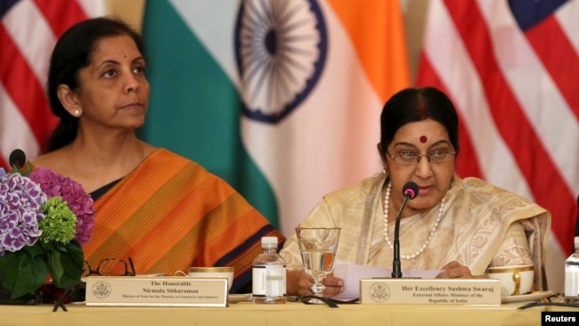 FILE - India's then-minister of commerce and industry, now minister of defense, Nirmala Sitharaman (L) and foreign minister Sushma Swaraj are seen at a U.S-India Strategic & Commercial Dialogue plenary session at the State Department, in Washington, Sept. 22, 2015.