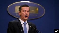Romania's Prime Minister Sorin Grindeanu addresses reporters during a statement in Bucharest, Feb. 4, 2017. After mass protests that have rocked the country for days, Romania's government says it will repeal an emergency decree that decriminalizes officia