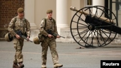 British troops patrol an army barracks near the scene of a killing in Woolwich, southeast London May 23, 2013. British authorities believe that two men accused of hacking a soldier to death on a London street in revenge for wars in Muslim countries are Br