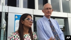 Alan Morison, right, Australian editor of the website Phuketwan and his colleague Chutima Sidasathien speak to the media ahead of their appearance in court to face charges of violating Thailand's Computer Crime Act in Phuket, Thailand, July 14, 2015.