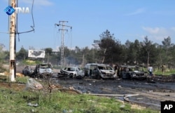 This image released by the Thiqa News Agency shows charred and damaged cars at the scene of an explosion in the Rashideen area, a rebel-controlled district outside Aleppo city, Syria, April. 15, 2017.