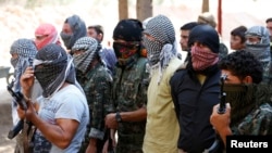 Iraqi volunteers from the Yazidi sect gather during a training camp at the Serimli military base, which is controlled by the Kurdish People's Protection Units (YPG), in Qamishli, northeastern Syria on the border with Kurdistan August 16, 2014. The YPG is 