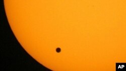 This June 2004 photo shows the transit of Venus, which occurs when Venus passes between the Earth and the sun. 