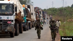 African Union peacekeepers guard a commercial convoy making its way to the border of Cameroon, near Bangui, Central African Republic, March 8, 2014.