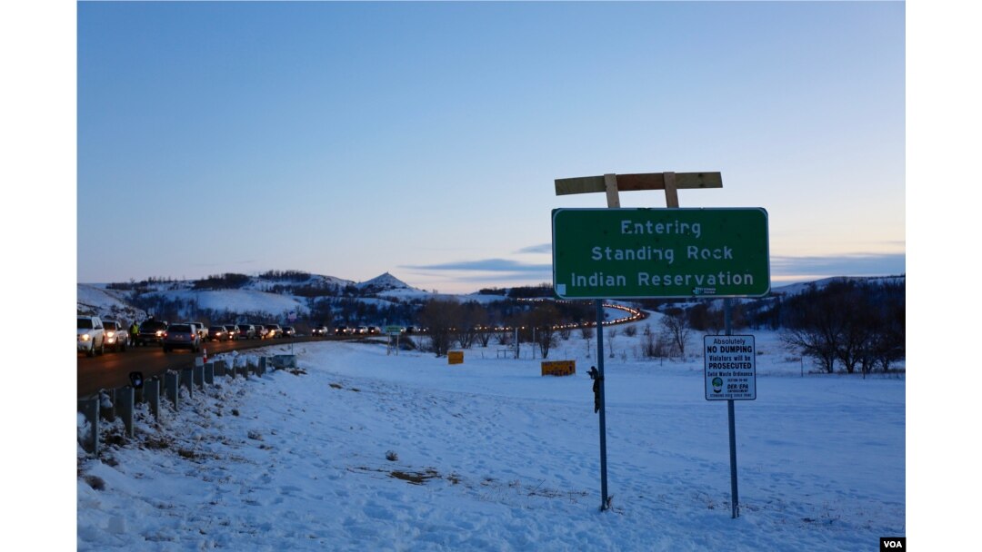 Cars are slowed down by security as they enter the camp at Standing Rock, where thousands have been living in protest of an oil pipeline planned through Native American land (E. Sarai/VOA)
