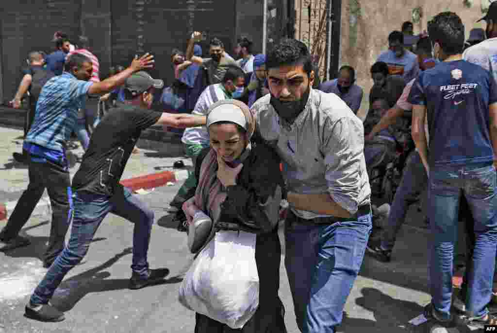 Palestinians evacuate a building targeted by Israeli bombardment in Gaza City.