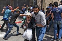 Palestinians evacuate a building targeted by Israeli bombardment in Gaza City on May 11, 2021.