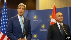 Turkey's Minister of Foreign Affairs Mevlut Cavusoglu, right, and U.S. Secretary of State John Kerry speak to the media before a meeting in Ankara, Sept. 12, 2014.