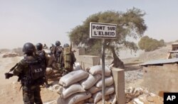 Cameroon soldiers stand guard at a lookout post near the village of Fotokol as they take part in operations against the Islamic extremist group Boko Haram, Feb. 25, 2015.