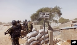 FILE - Cameroon soldiers stand guard at a lookout post near the village of Fotokol as they take part in operations against the Islamic extremists group Boko Haram, Feb. 25, 2015.