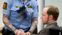 Petugas polisi melepas borgol yang terpasang di tangan Anders Behring Breivik, terdakwa kasus pembunuhan terhadap 77 orang di Norwegia pada 2011, dalam sidang kasus tersebut pada 4 Juni 2012. (Foto: Reuters/Heiko Junge/NTB Scanpix/Pool) 