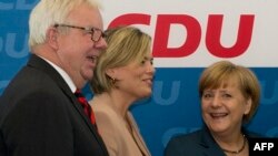 FILE - (L-R) Michael Fuchs, member of the CDU parlamentary fraction, Julia Kloeckner, Vice-Chairman of the CDU and German Chancellor Angela Merkel arrive for their party's executive board meeting in Berlin, Sept. 6, 2013. 