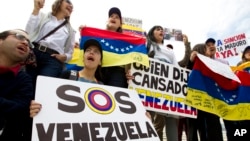 FILE - Demonstrators who are against the Venezuelan government chant outside of the Organization of American States (OAS) during the special meeting of the Permanent Council, in Washington, April 3, 2017, to consider the recent events in Venezuela.