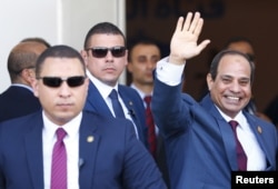 FILE - Egyptian President Abdel Fattah el-Sissi waves during the opening ceremony of the new Suez Canal, in Ismailia, Aug. 6, 2015. The former military leader is consolidating his control of the country, experts say.