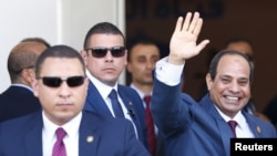 FILE - Egyptian President Abdel Fattah el-Sissi waves during the opening ceremony of the new Suez Canal, in Ismailia, Aug. 6, 2015. The former military leader is consolidating his control of the country, experts say.