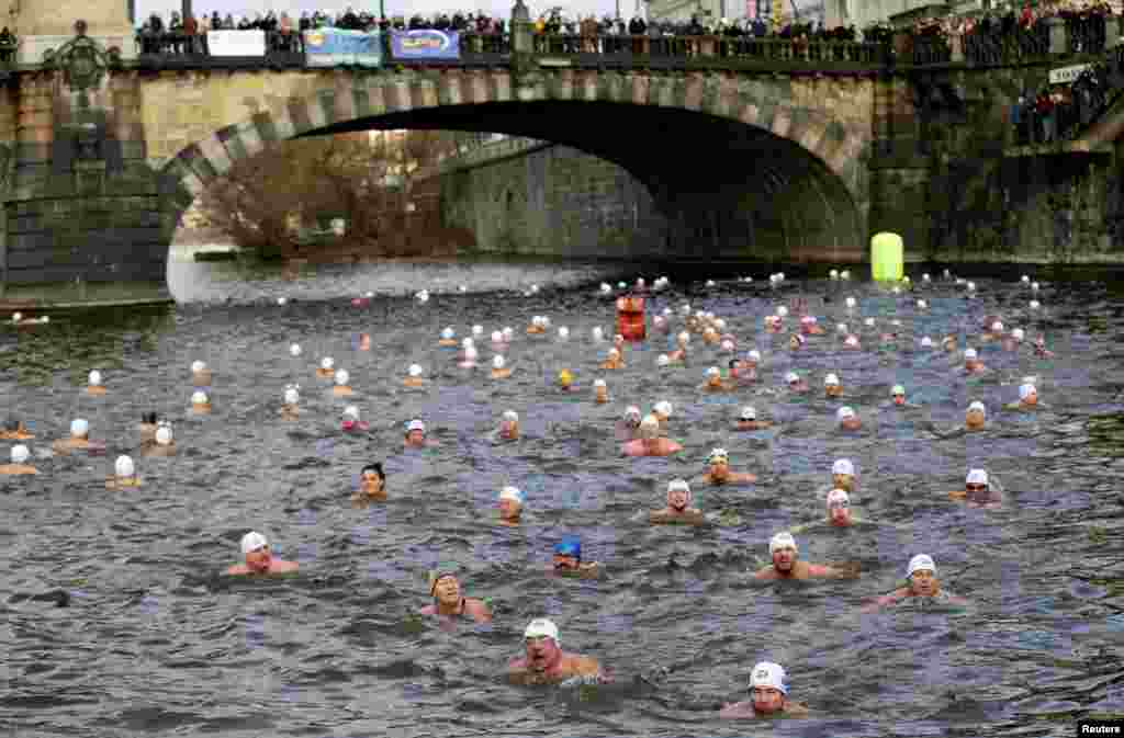 Swimmers participate in the annual Christmas winter swimming competition in the Vltava river in Prague, Czech Republic.