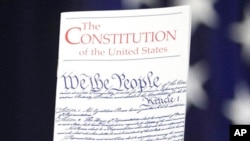 FILE - In this March 23, 2016 photo, the Constitution is held by a member of Congress on Capitol Hill in Washington. President Donald Trump says he wants to order the end of the constitutional right to citizenship for babies of non-citizens and unauthorized immigrants born in the United States. (AP Photo/J. Scott Applewhite)