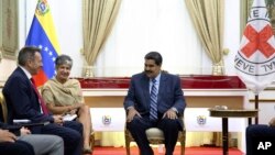Photo released by Miraflores Press Office shows Venezuela's President Nicolas Maduro (R) meeting with Peter Maurer, president of the International Committee of the Red Cross, at the Miraflores Presidential Palace in Caracas, April 9, 2019. 