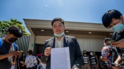 Phansuwan Nakeaw, center, stands outside the Embassy of Japan in Bangkok, Thailand, Tuesday, Aug. 25, 2020, requesting that the self-exiled in Japan, Pavin Chachavalpongpun, administrator of the Facebook group “Royalist Marketplace” be deported back to Thailand.