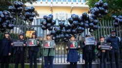 Members of Reporters Without Borders demonstrate outside the Russian Embassy in Paris, Oct. 6, 2021, to pay tribute to Russian journalist Anna Politkovskaya, who was shot dead on Oct. 7, 2006, in Moscow.