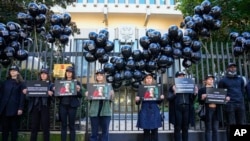 Members of Reporters Without Borders demonstrate outside the Russian Embassy in Paris, Oct. 6, 2021, to pay tribute to Russian journalist Anna Politkovskaya, who was shot dead on Oct. 7, 2006, in Moscow.