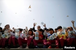 FILE - Children release butterflies during an event to wish for a successful inter-Korean summit, near the demilitarized zone separating the two Koreas in Paju, South Korea, April 25, 2018.