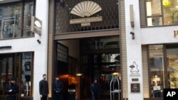 FILE - Doormen wait outside the Mandarin Oriental hotel, Jan.22, 2019 in Paris. 