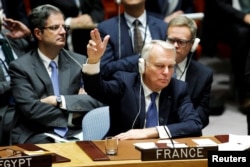 FILE - France's Foreign Minister Jean-Marc Ayrault votes in favor of a draft resolution that demands an immediate end to airstrikes and military flights over Syria's Aleppo city, during a meeting of Members of Security Council at the U.N. Headquarters in New York, Oct. 8, 2016.