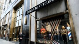A lone woman window shops along a sparsely occupied Fifth Avenue, Wednesday, March 18, 2020 in New York. (Photo by Evan Agostini/Invision/AP)