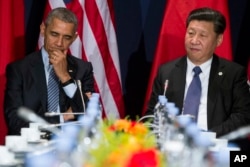 ປ. ສຫລ. ທ່ານ Barack Obama (ຊ້າຍ), ພົບປະກັບປະທານປະເທດຈີນ ທ່ານ Xi Jinping ນອກສະໜາມ ໃນກອງປະຊຸມກ່ຽວກັບການປ່ຽນແປງຂອງດິນຟ້າອາກາດຂອງໂລກ, ທີ່ Le Bourget, ຂ້າງນອກປາຣີ, 30 ພະຈິກ, 2015.