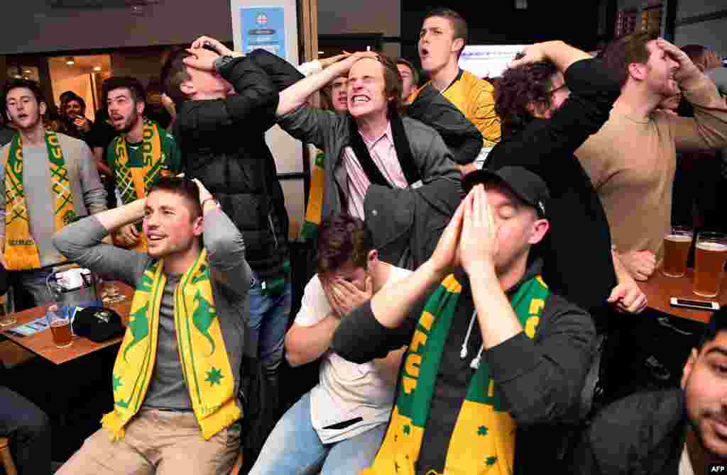 Australian fans in a pub in Melbourne react as they watch on a giant screen as Australia plays Peru during a 2018 World Cup Group C football match in St. Petersburg.