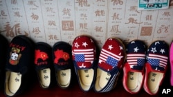 Chinese-made children shoes carrying a Chinese map and U.S. flags are on display for a sale at a shop in Beijing, July 13, 2018. 