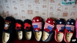 FILE - Chinese-made children shoes carrying a Chinese map and U.S. flags are on display for a sale at a shop in Beijing, July 13, 2018. 