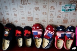 FILE - Chinese-made children shoes carrying a Chinese map and U.S. flags are on display for a sale at a shop in Beijing, July 13, 2018.