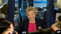 Democratic presidential candidate Hillary Clinton speaks with members of the media on board her campaign plane at Westchester County Airport in White Plains, N.Y., Sept. 27, 2016. 