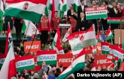 HUNGARY -- Hungarian Prime Minister Viktor Orban waves during his speech outside the Hungarian Parliament building in Budapest, Hungary, Thursday, March 15, 2018 during celebrations of the Hungarian national holiday.