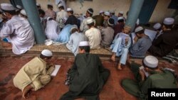 FILE - Pakistani religious students attend a lesson at Darul Uloom Haqqania, an Islamic seminary and alma mater of several Taliban leaders in Akora Khattak, Khyber Pakhtunkhwa province.
