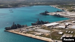 FILE - Navy vessels are moored in port at the U.S. Naval Base Guam at Apra Harbor, Guam, March 5, 2016. 
