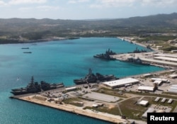 FILE - Navy vessels are moored in port at the U.S. Naval Base Guam at Apra Harbor, Guam, March 5, 2016.