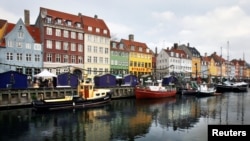 FILE - Boats are anchored in the Nyhavn district of Copenhagen, Denmark, Dec. 5, 2009. Global watchdog Transparency International said Wednesday its latest annual Corruption Perceptions Index report Denmark and New Zealand performed best in 2016, with scores of 90.