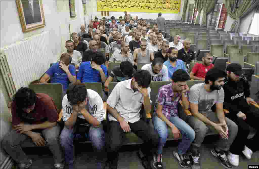 Syrians detainees, who were arrested over participation in the protests against Syrian President Bashar al-Assad&#39;s regime, at the Damascus police leadership building to sign their release papers, July 11.