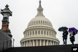 Tourists arrive to visit the U.S. Capitol on a rainy morning in Washington, Dec. 28, 2018, during a partial government shutdown.