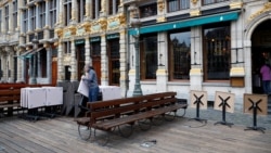 An employee prepares the terraces of a bar in central Brussels, as the country began easing lockdown restrictions following the coronavirus disease (COVID-19) outbreak in Belgium, June 4, 2020.